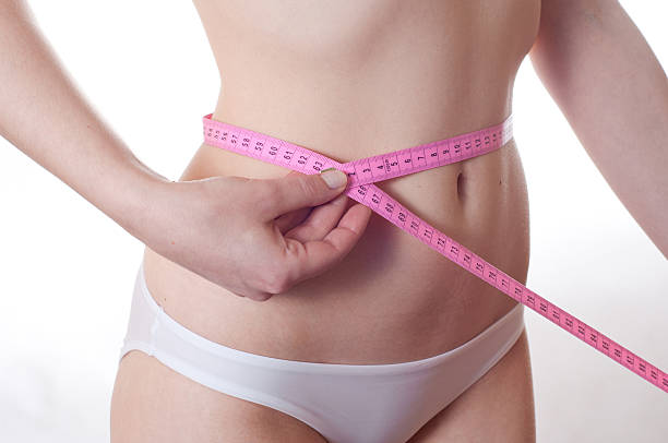 istock girl measures waist volume 177251074