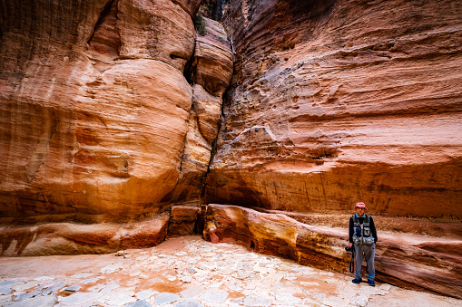 Petra, Jordan - March 29, 2019: One tourist alone in gorge of Petra, Jordan, one of the world most famous sites