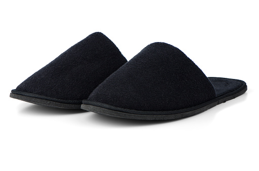 A pair of black slippers on a white background.