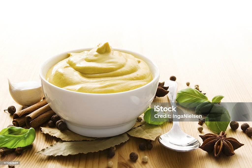 Mustard in bowl Fresh mustard in a bowl with spices and a spoon. Allspice Stock Photo