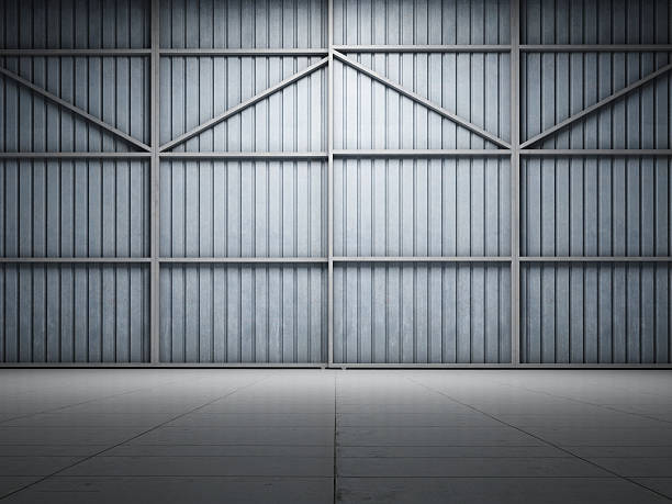 Large warehouse door illuminate Large warehouse door illuminate spot light airplane hangar photos stock pictures, royalty-free photos & images