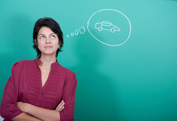Woman standing in front of a blackboard stock photo