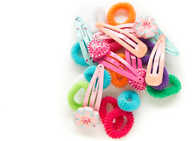 Girl's Hair Barettes and Bobbins Girl's colorful hair barettes (slides) and bobbins. hair clip stock pictures, royalty-free photos & images