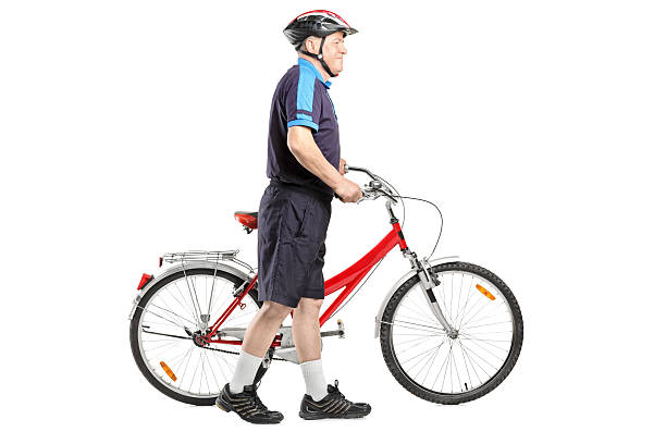 istock Senior bicyclist pushing a bicycle 177255976