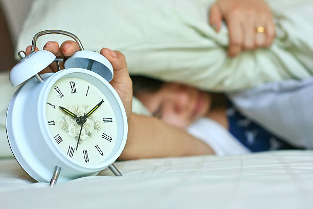 istock Woman turning off the alarm clock 177256432