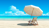 Sunlounger and umbrella on deserted tropical beach