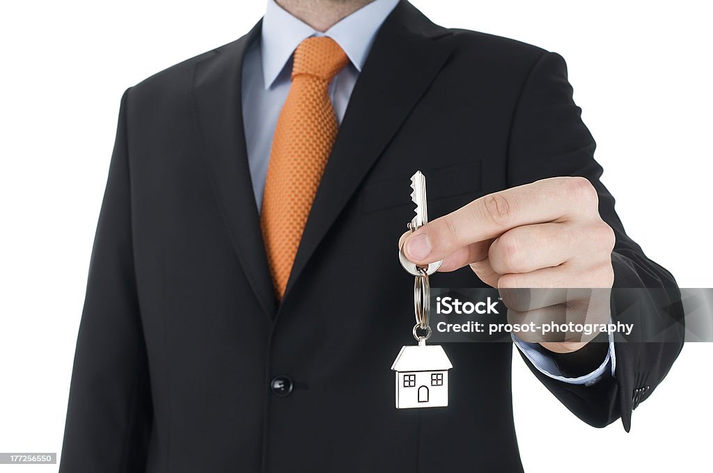 man in black suit holding a key Adult Stock Photo