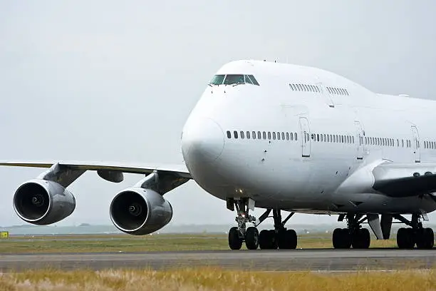 Boeing 747 jumbo jet taxis on the runway