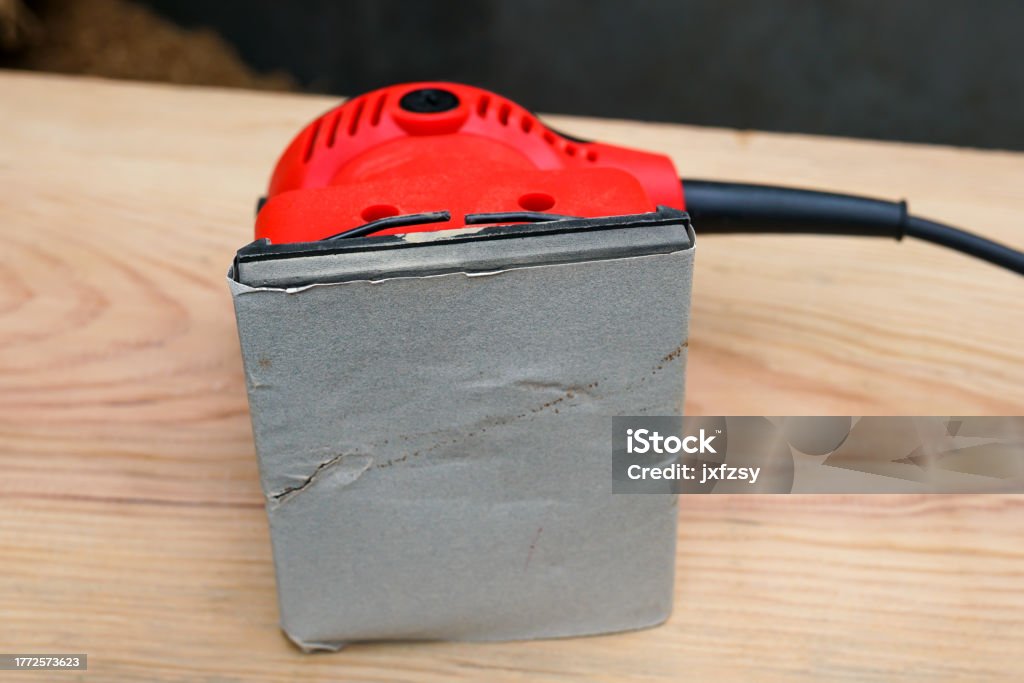 angular grinding machine on wooden surface Art And Craft Stock Photo