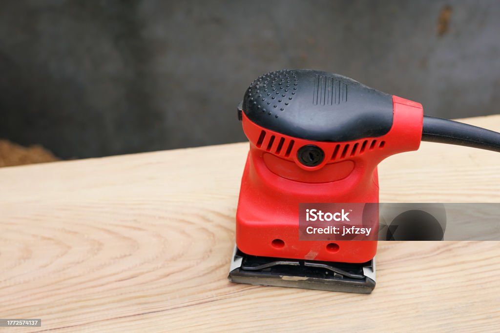 angular grinding machine on wooden surface Art And Craft Stock Photo