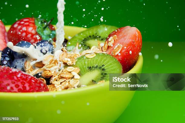 Adding Milk To Muesli With Fruits Breakfast Stock Photo - Download Image Now - Berry, Berry Fruit, Bowl