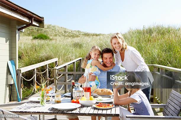 Family On Vacation Eating Outdoors Stock Photo - Download Image Now - Family, Beach, Chalet