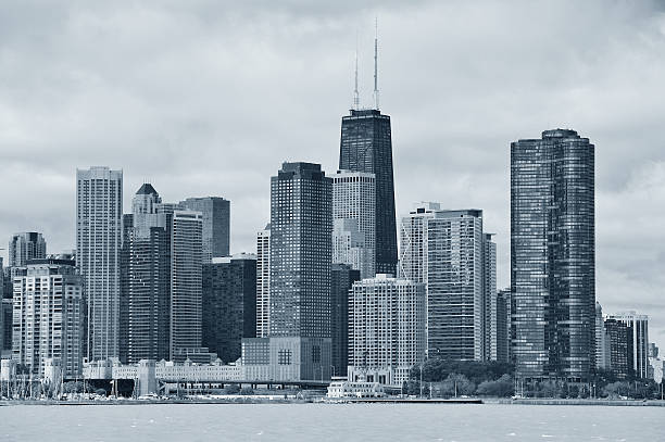 Chicago city urban skyline Chicago city urban skyline black and white with skyscrapers over Lake Michigan with cloudy blue sky. lake michigan photos stock pictures, royalty-free photos & images