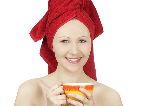 istock Young woman with towel drinking tea 177259428