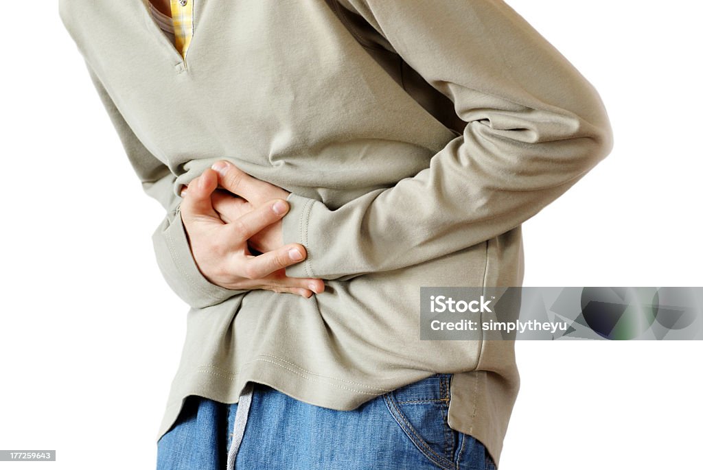 Stomach pain boy holding hands on his stomach over white background, pain Abdomen Stock Photo