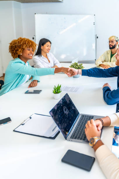 istock Multi-ethnic people greeting shaking hands on a meeting 1772596600
