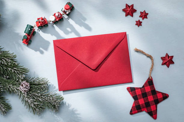 istock Christmas flat lay composition with red decorations. Letter to Santa and Christmas Tree Branch on Blue Background 1772597190