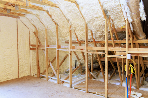 New home under construction with spray foam thermal hydro insulation on walls