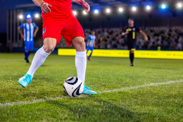 istock Soccer player leg kicking ball 1772607625