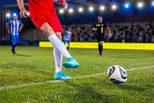 istock Soccer player leg kicking ball 1772607630