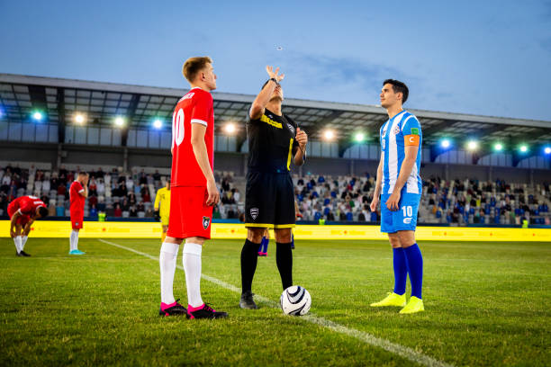 istock Football referee and team captains flipping coin 1772607634