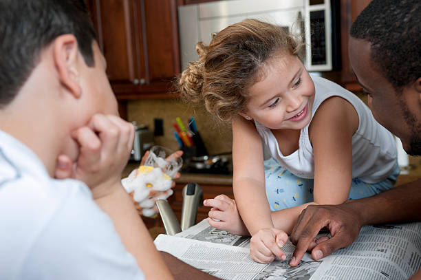 istock Multi ethnic family reading newspaper in the kitchen 177261066