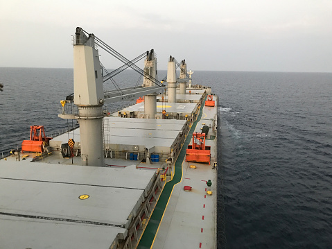 Merchant ship carrying bulk cargo is underway at sea in the morning