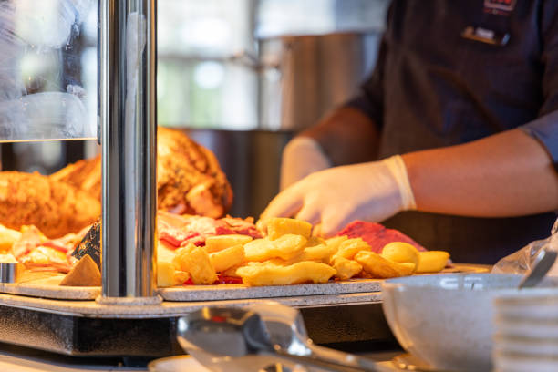Details on hands cutting the meat