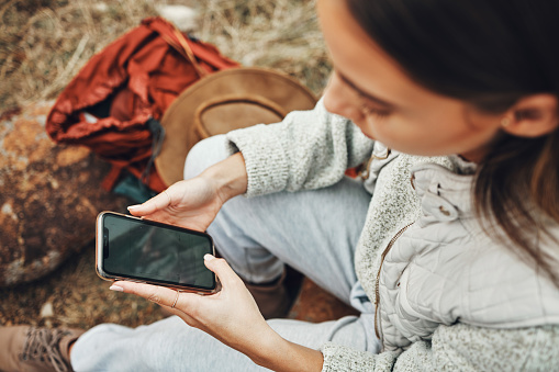 Woman, hands and phone screen on camp for social media, navigation or outdoor communication in nature. Closeup of female person with mobile smartphone display, app or mockup for networking or search