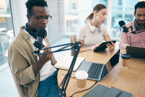 istock Man, microphone and podcast or recording, streaming or creative conversation. Diversity, group and black male person or laptop in office for social network, influencer or live online content creating 1772621297