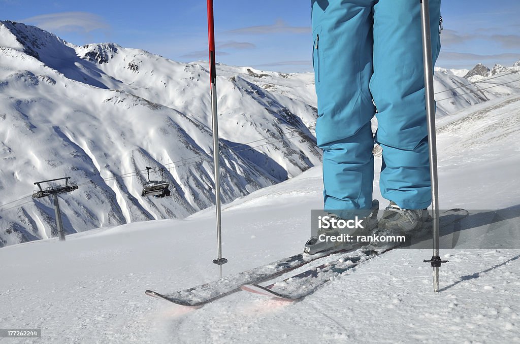 legs in ski boots on skis "woman's legs in ski boots, standing on skis" Activity Stock Photo