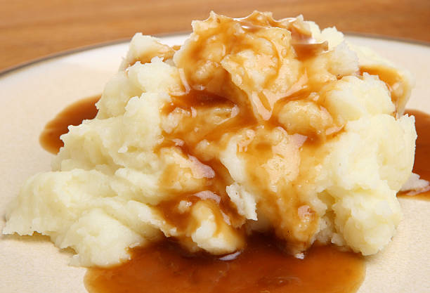 Mashed Potato with Gravy Mashed potato with gravy poured over. mashed potatoes stock pictures, royalty-free photos & images