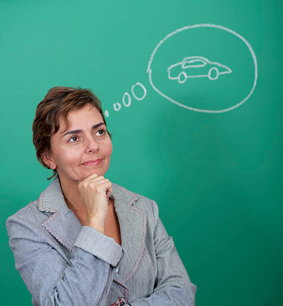 Woman standing in front of a blackboard stock photo