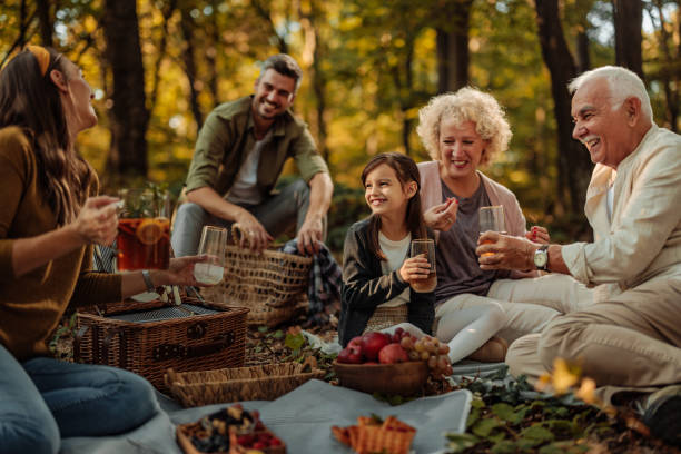 istock Whole Caucasian family having a picnic in the forest while drinking juice 1772643479