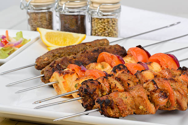 istock Six kebabs lined up next to spices and a slice of lemon 177264390