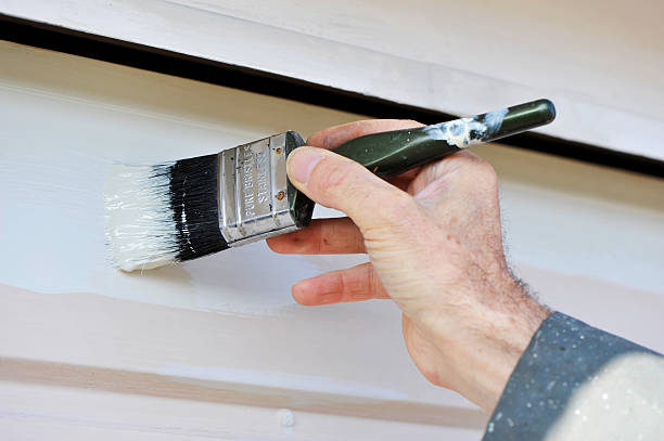 istock Hand holding a brush and painting a wall 177264624