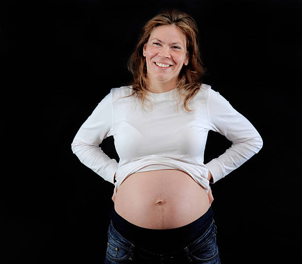 Pregnant woman with heart shape on stomach made with red crayon