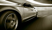 Silver car speeding in tunnel