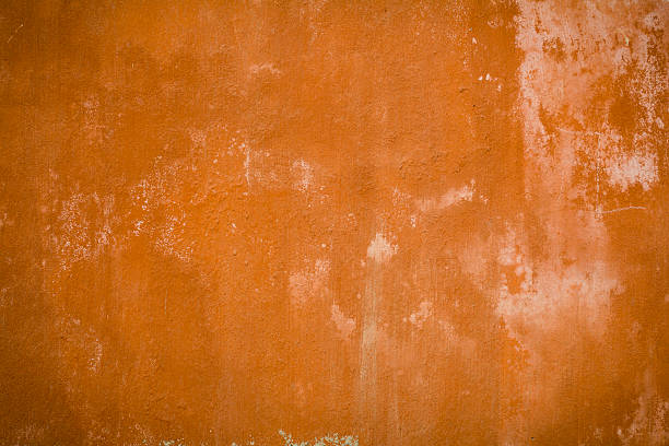 istock Grunge, orange colored background of a wall 177265414