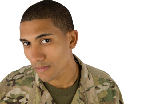 A African American soldier stares into the camera