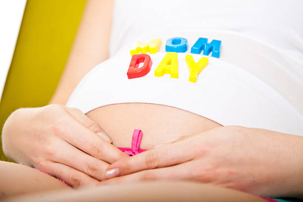 istock Pregnant belly with tulips flowers isolated on white 177267592