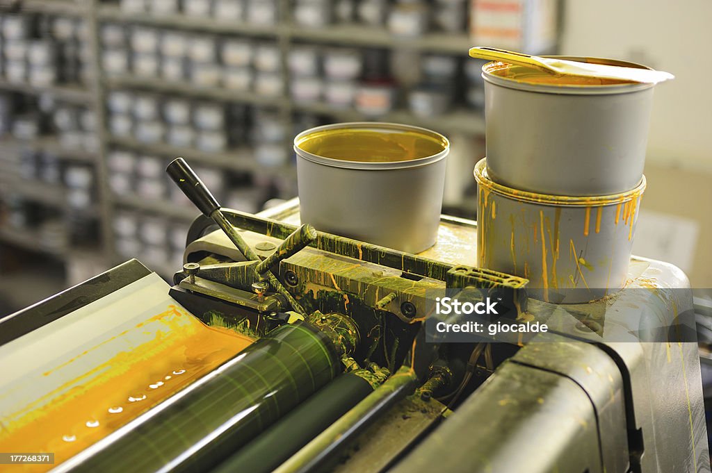 offset printing machine detail of the offset printing machine with cans of yellow color Manufacturing Stock Photo