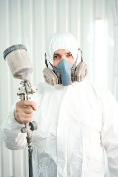 istock Serious worker with painting tool in hand standing in workshop 1772688138