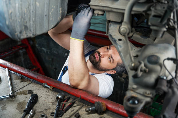 istock Focused automotive service technician is fixing automobile in inspection pit 1772688686