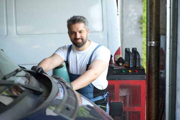 istock Smiling auto service technician is posing for camera in garage 1772688822