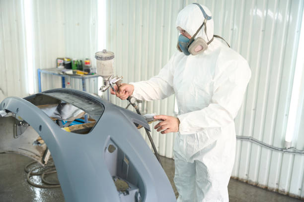 istock Experienced auto detailer applying paint to car body panel 1772689319
