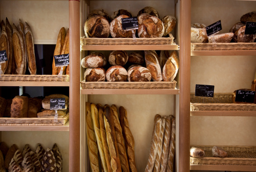 a wall of freshly baked bread at a French bakery in Paris