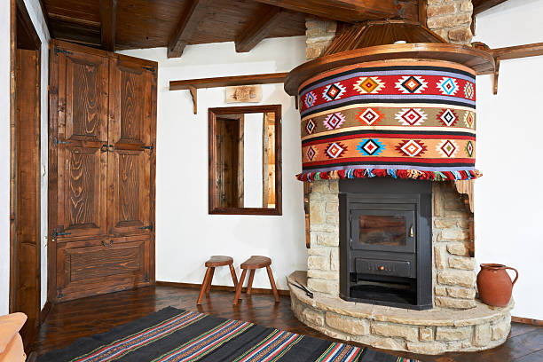 Traditional interior design of room with fireplace in old wooden Bulgarian house