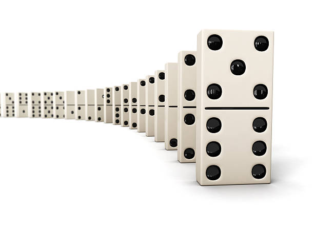 Dominoes lined up in a row against a white background