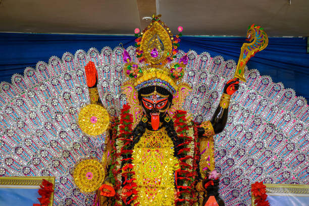 Idol of Goddess Maa Kali at a decorated puja pandal in Kolkata, West Bengal, India. Kali puja also known as Shyama Puja is a famous religious festival of Hinduism. Idol of Goddess Maa Kali at a decorated puja pandal in Kolkata, West Bengal, India. Kali puja also known as Shyama Puja is a famous religious festival of Hinduism. menakshi stock pictures, royalty-free photos & images